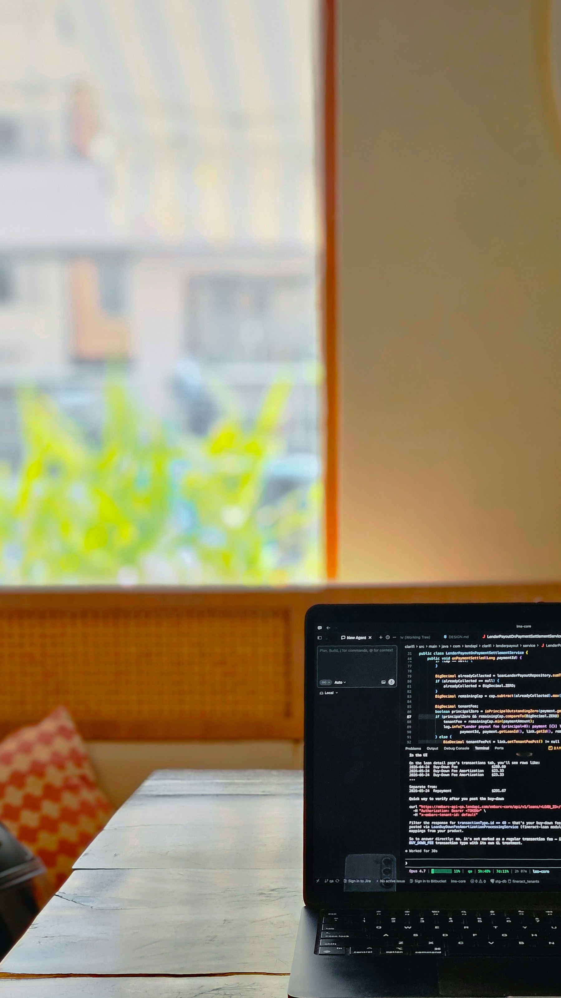Laptop showing code on a wooden table by a window for this Soran Ari article about technology learning